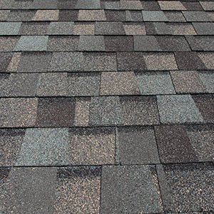 Chandler's Roofing Asphalt Roofing - Close up of mult-gray colored roofing shingles